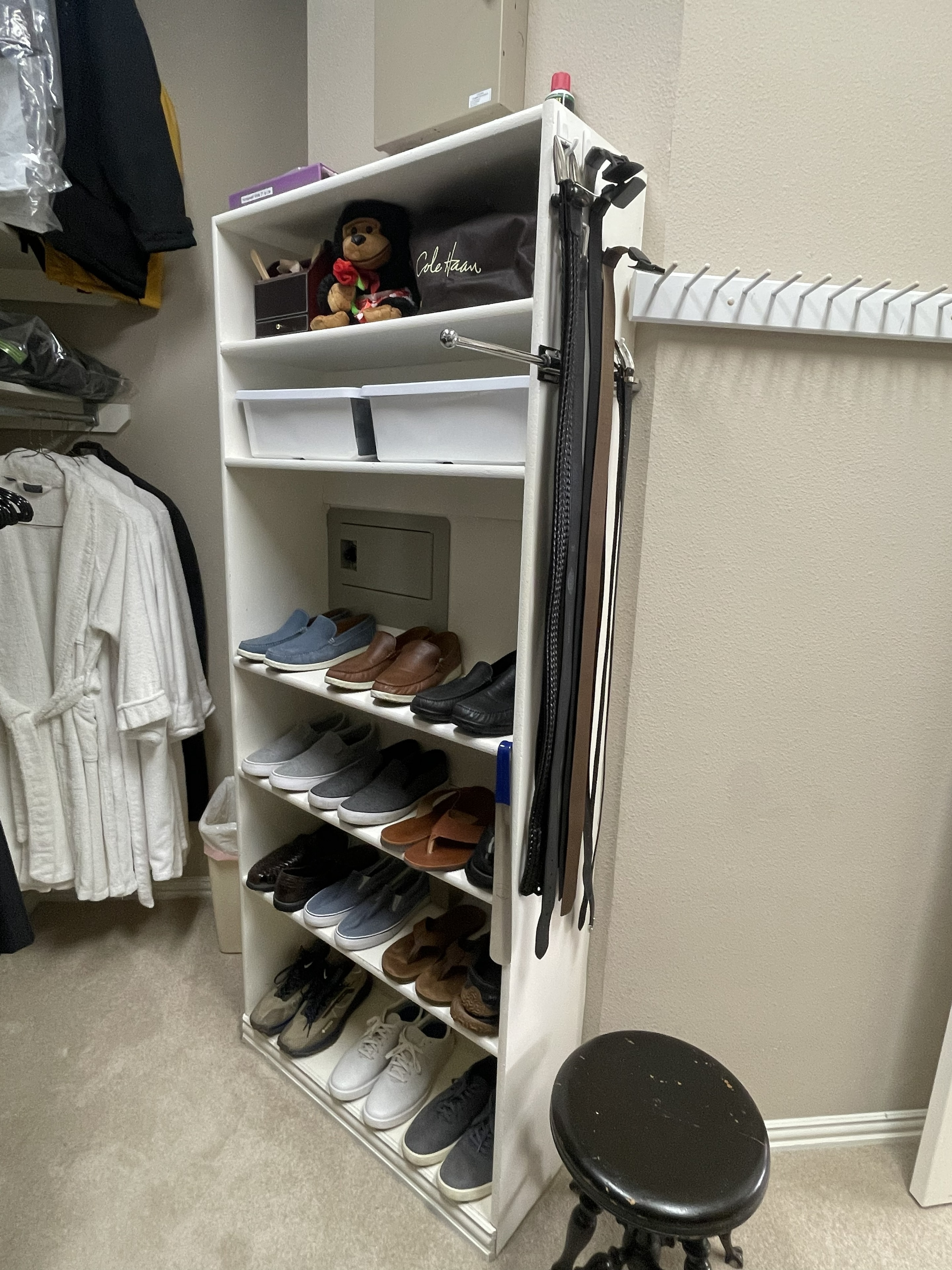 Shoe rack and accessories neatly organized on white shelving